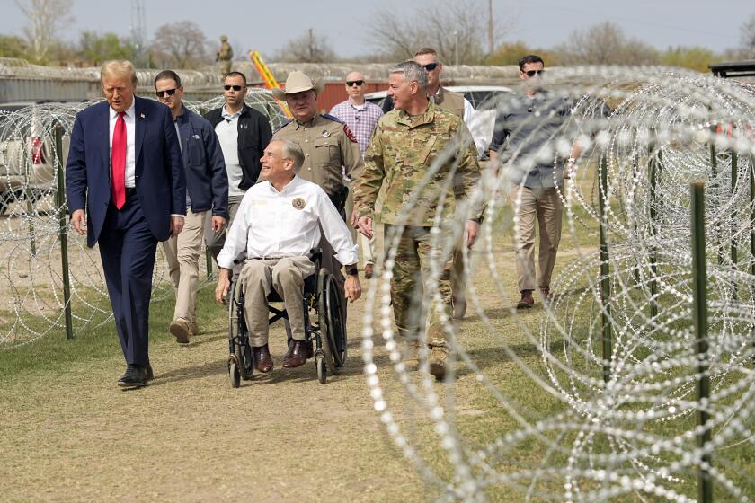 FILE - Republican presidential candidate former President Donald Trump talks with Texas Gov. Greg Abbott during a visit to the U.S.-Mexico border, Feb. 29, 2024, in Eagle Pass, Texas. As Trump campaigns on the promises of mass deportations and pardons for those convicted in the Jan. 6 Capitol attack, his ideas are being met with little pushback by a new era of Republicans in Congress. It's a shift from the first time around when Trump encountered early skepticism and, once in a while, the uproar of condemnation. (AP Photo/Eric Gay, File)