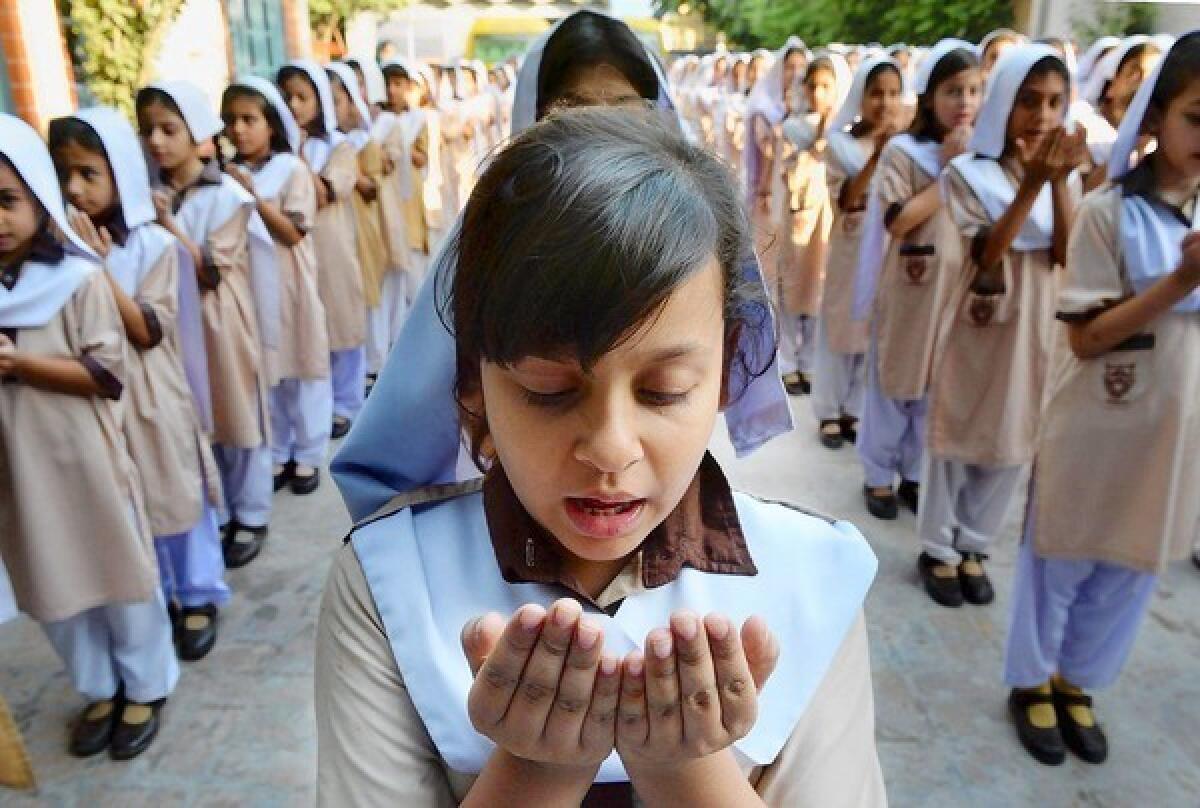 Pakistani school girls pray for the early recovery of child activist Malala Yousafzai, who was shot in the head in a Taliban assassination attempt.