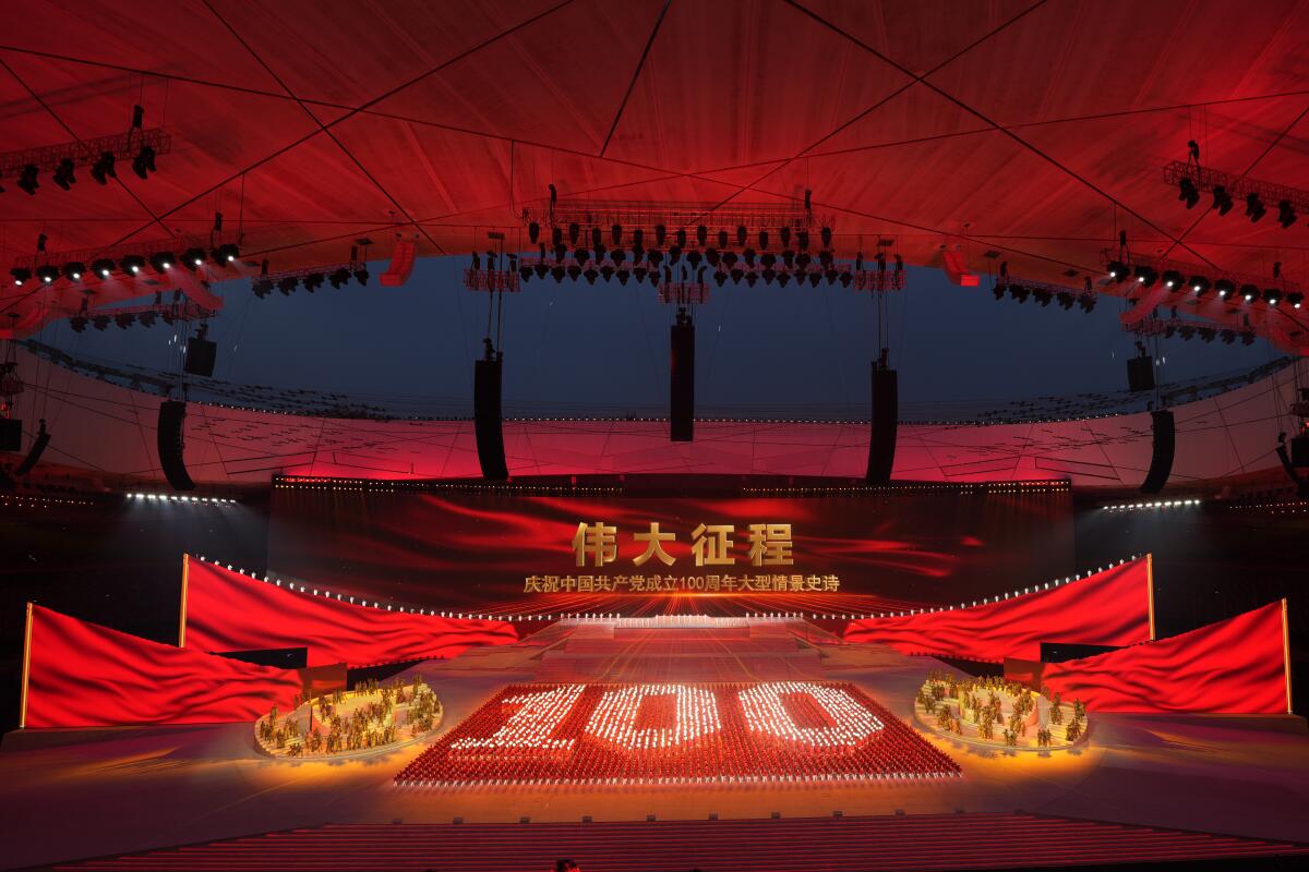 Performers form the number 100 at a gala show ahead of the 100th anniversary of the founding of the Chinese Communist Party in Beijing Monday, June 28, 2021. China's Communist Party, celebrated its 100th birthday on Thursday, July 1. (AP Photo/Ng Han Guan)