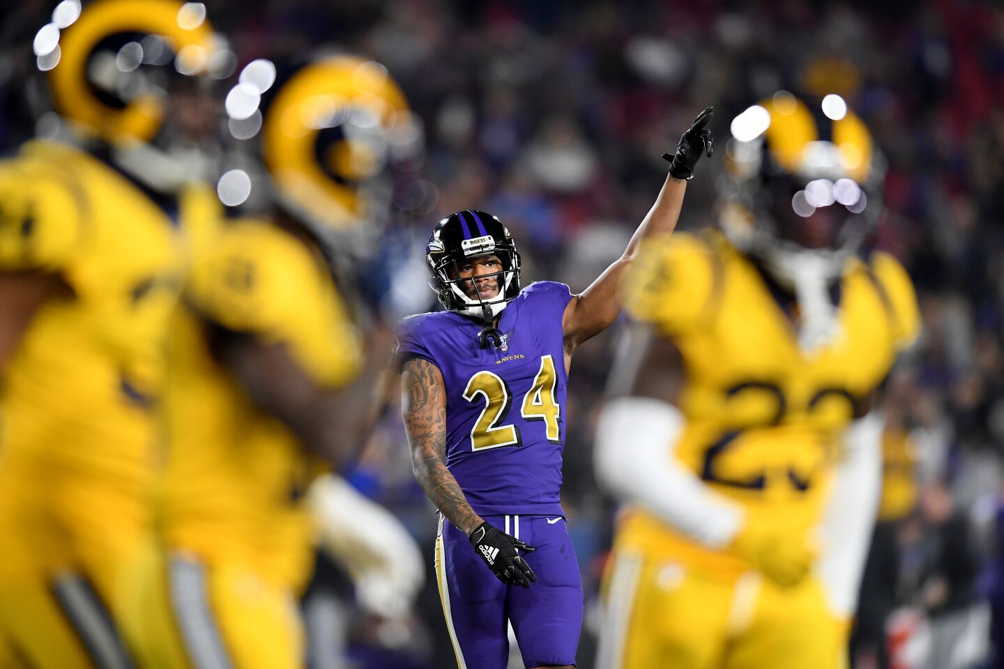 Ravens cornerback Marcus Peters taunts his former team as the Rams come off the field during the fourth quarter of a game Nov. 25 at the Coliseum.