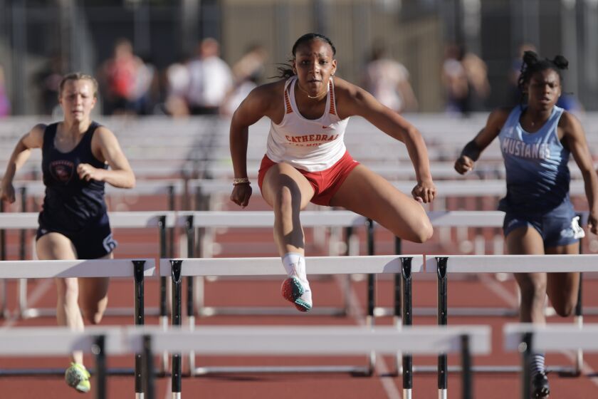 ESCONDIDO, CA - APRIL 21, 2023: Cathedral Catholic's Kapiolani Coleman runs toward the finish line to win section 3 of the girls 100 meter hurdles during the 2023 Escondido Invitational at Escondido High School in Escondido on Friday, April 21, 2023. (Hayne Palmour IV / For The San Diego Union-Tribune)