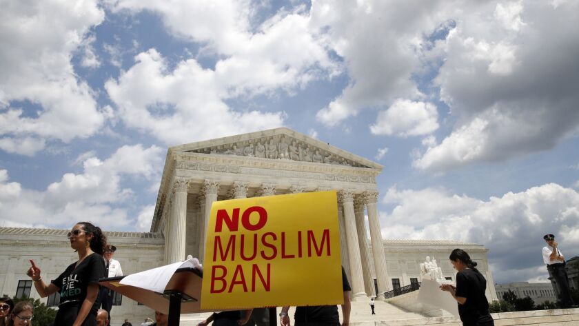 People protest against the Supreme Court ruling upholding President Donald Trump's travel ban outside the the Supreme Court in Washington on June 26.