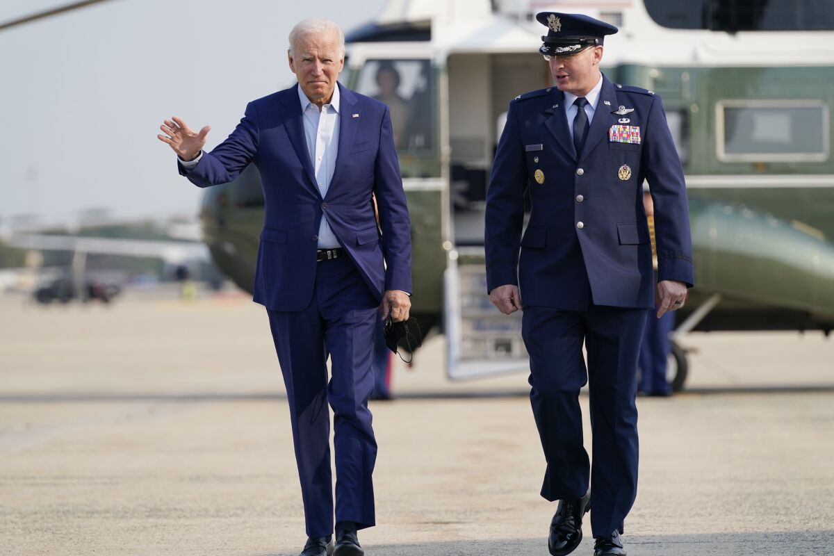 President Joe Biden arrives to board Air Force One for a trip to visit the National Interagency Fire Center in Boise, Idaho, Monday, Sept. 13, 2021, in Andrews Air Force Base, Md. Biden is escorted by Col. William McDonald the Vice Commander of the 89th Airlift Wing. (AP Photo/Evan Vucci)