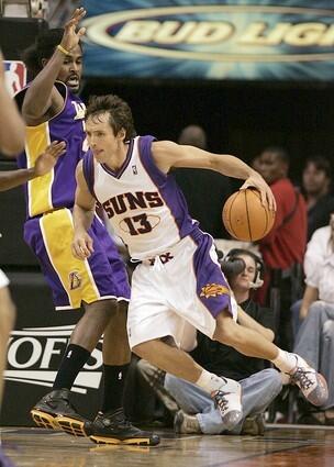 Phoenix's Steve Nash leaves his feet to make a move as Ronny Turiaf attempts to defend.