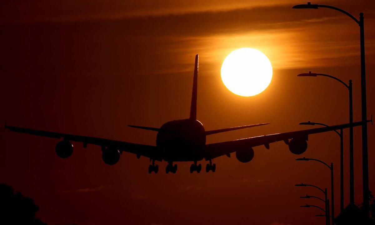 A plane lands at Los Angeles International Airport.