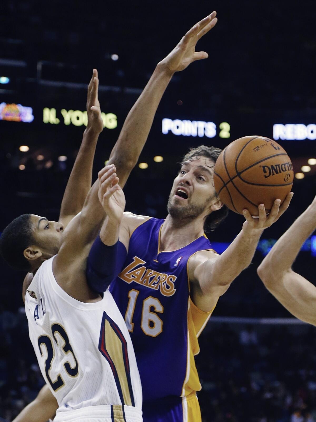 Lakers forward Pau Gasol, right, tries to put up a shot over New Orleans Pelicans forward Anthony Davis during the Lakers' 96-85 loss Friday.