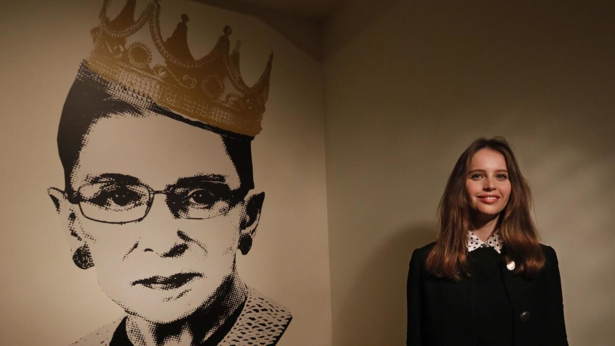 Felicity Jones, who plays Ruth Bader Ginsburg in the film "On the Basis of Sex," stands by an image of the Supreme Court justice at the Skirball Cultural Center's exhibit "Notorious RBG: The Life and Times of Ruth Bader Ginsburg." The center has free admission Sunday.