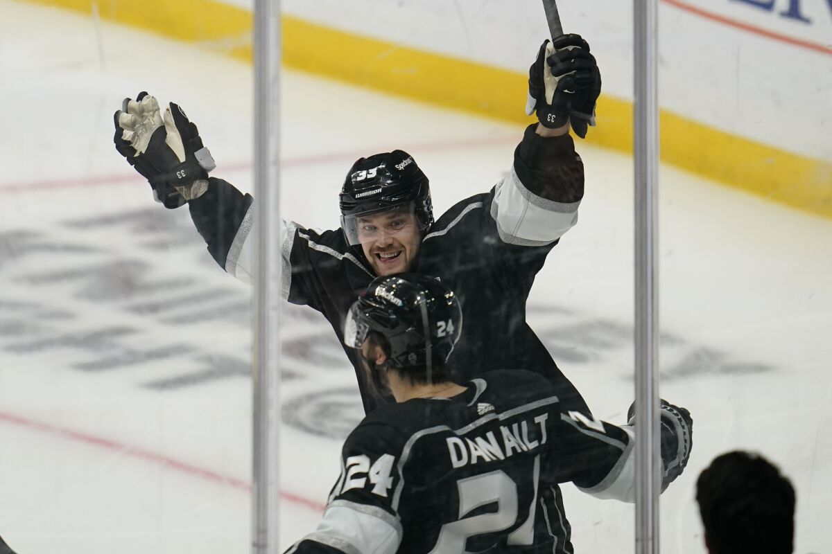 Los Angeles Kings left wing Viktor Arvidsson (33) celebrates with center Phillip Danault (24) after Danault scored during the second period of an NHL hockey game against the New York Rangers Monday, Jan. 10, 2022, in Los Angeles. (AP Photo/Ashley Landis)
