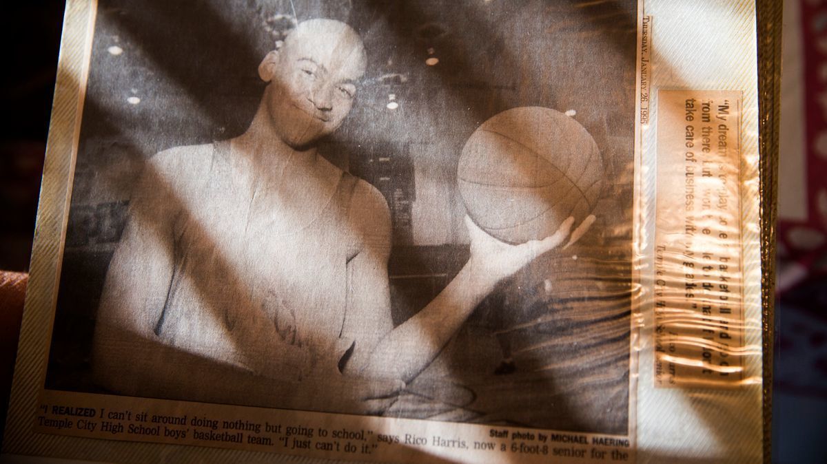 Margaret Fernandez displays a newspaper clipping featuring her son, Rico Harris, in her photo album at her Alhambra house. Harris vanished in 2014.