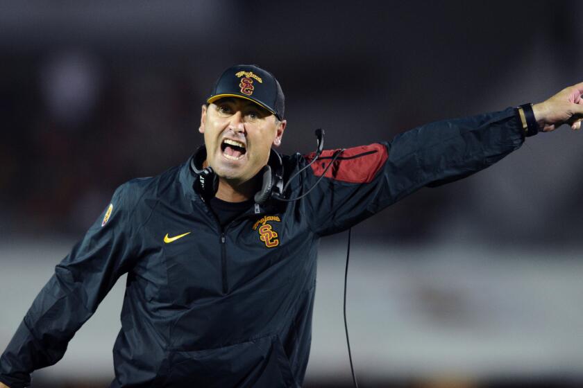 Steve Sarkisian argues with an official while coaching at USC in October.
