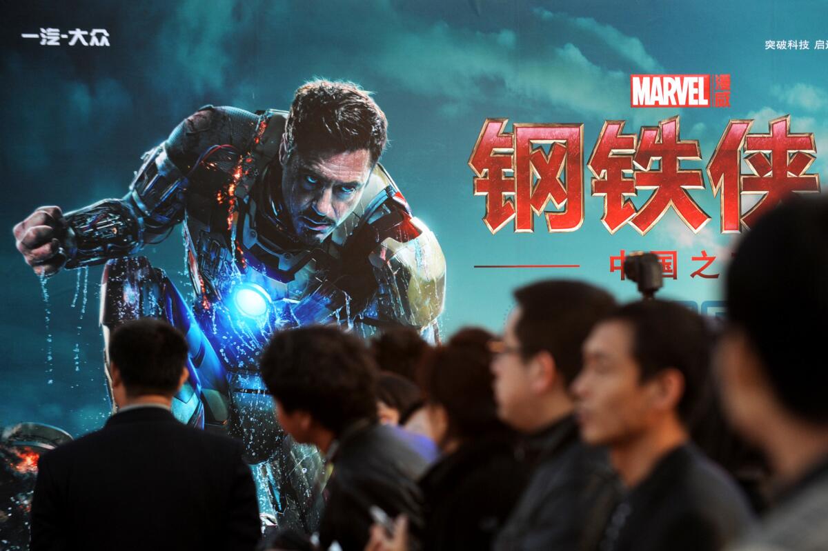 An audience in Beijing attends a promotional event for the movie ''Iron Man 3.'' That movie was one of the many that did well in the global market.