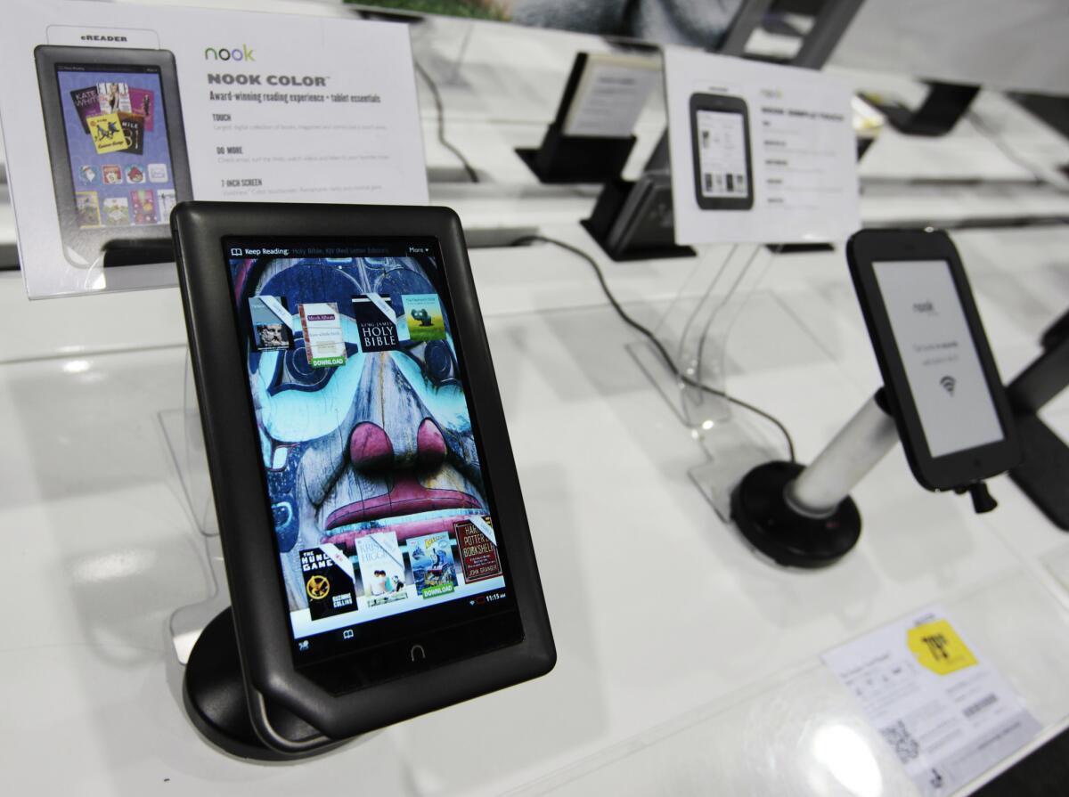 A Barnes & Noble Nook Color eReader, left, is shown next to a Nook Simple Touch eReader on display at a Best Buy in Mountain View, Calif.