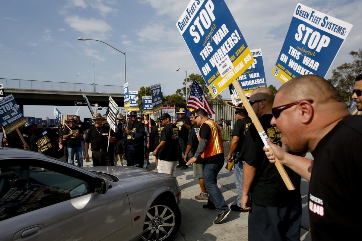 Port truck drivers went on strike Monday, alleging unfair labor practices by their employers. It's the second time in three months that port truck drivers have gone on strike. Above, drivers rally outside Green Fleet Systems in Carson in August.