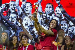 FILE - Spain's Jennifer Hermoso holds the trophy as they celebrate their Women's World Cup victory.
