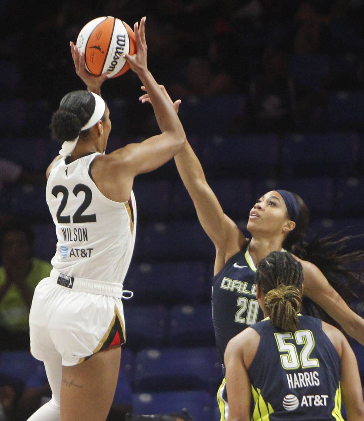 Dallas Wings forward Isabelle Harrison (20) defends against a jump shot by Las Vegas Aces forward A'ja Wilson (22) during first half of a WNBA basketball game at UT-Arlington's College Park Center in Arlington, Texas, Wednesday, June 15, 2022. (Steve Hamm/The Dallas Morning News via AP)