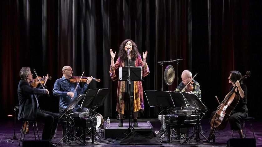 Mahsa Vahdat, center, with the Kronos Quartet (left to right, David Harrington, John Sherba, Hank Dutt and Sunny Yang) performing its "Music for Change: The Banned Countries" program at UC Santa Barbara's Campbell Hall on Tuesday night