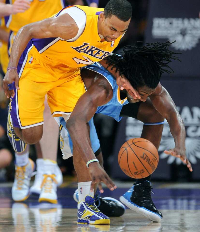 Lakers point guard Ramon Sessions and Nuggets forward Kenneth Faried collide as they chase down a loose ball during their game Friday night at Staples Center.