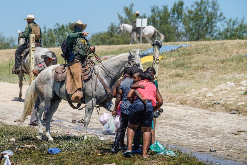 A United States Border Patrol agent on horseback tries to stop Haitian migrants from entering an encampment on the banks of the Rio Grande near the Acuna Del Rio International Bridge in Del Rio, Texas on September 19, 2021. - US law enforcement are attempting to close off crossing points along the Rio Grande river where migrants cross to get food and water, which is scarce in the encampment. The United States said Saturday it would ramp up deportation flights for thousands of migrants who flooded into the Texas border city of Del Rio, as authorities scramble to alleviate a burgeoning crisis for President Joe Biden's administration. (Photo by PAUL RATJE / AFP) (Photo by PAUL RATJE/AFP via Getty Images)