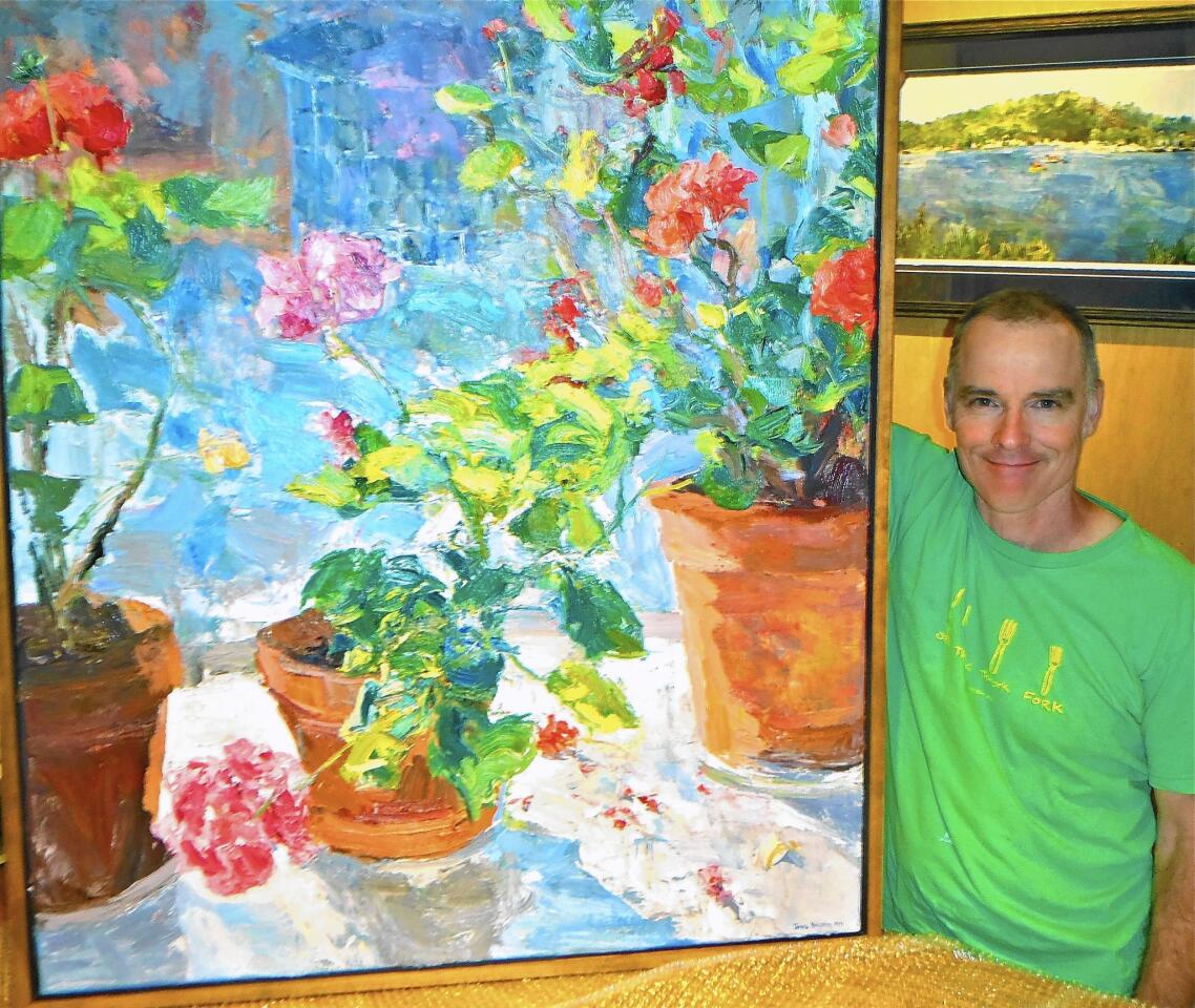 James Brandess with one of his still-life paintings in his gallery in Saugatuck.