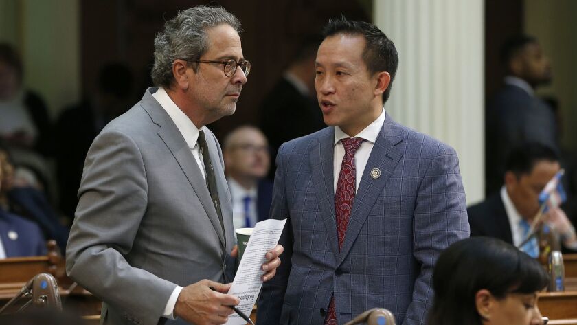 Democratic Assemblymen Richard Bloom of Santa Monica, left, and David Chiu of San Francisco talk during the Assembly session on May 29 in Sacramento. The Assembly approved Chiu's bill to cap rent increases, but only after major concessions to opponents.