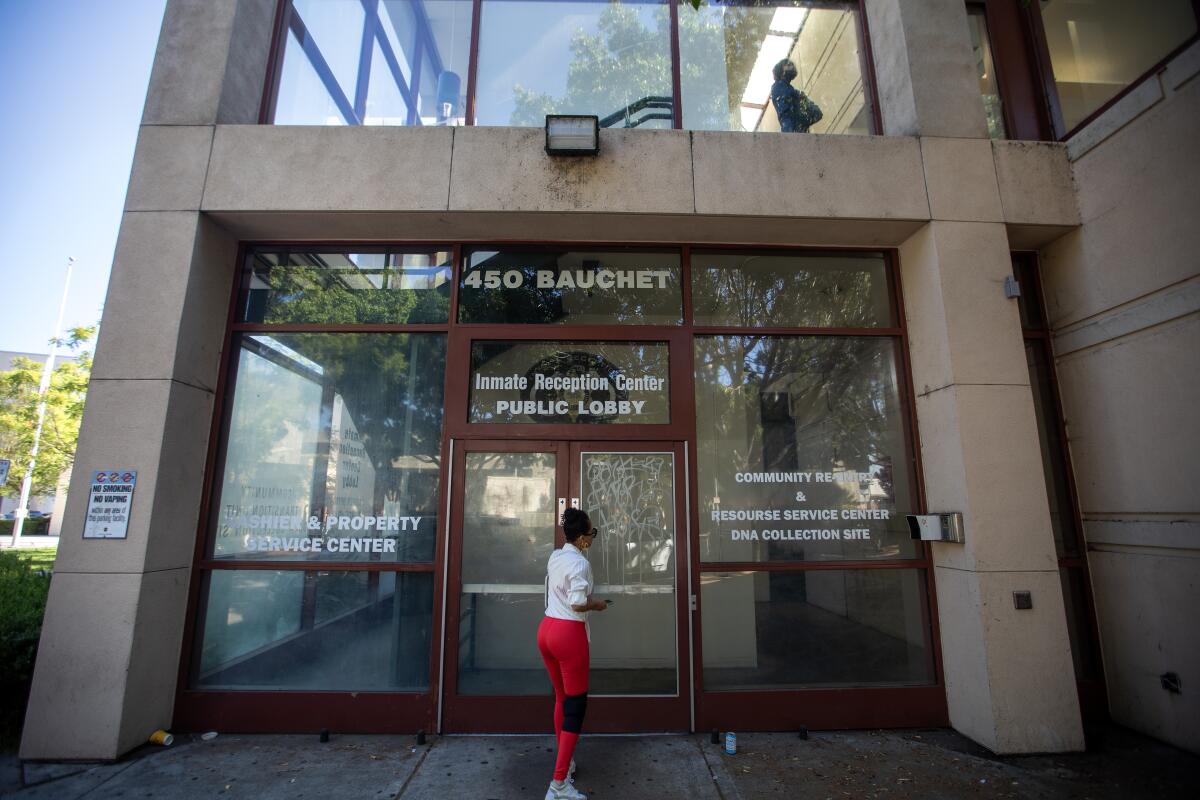 A person stands outside the public lobby of the L.A. Jail