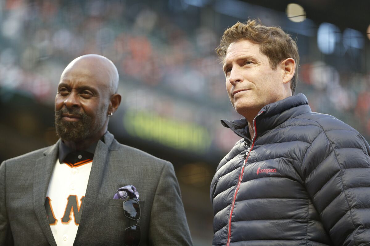 Former 49ers stars Jerry Rice, left, and Steve Young stand on the field before Game 1 of the NLDS.