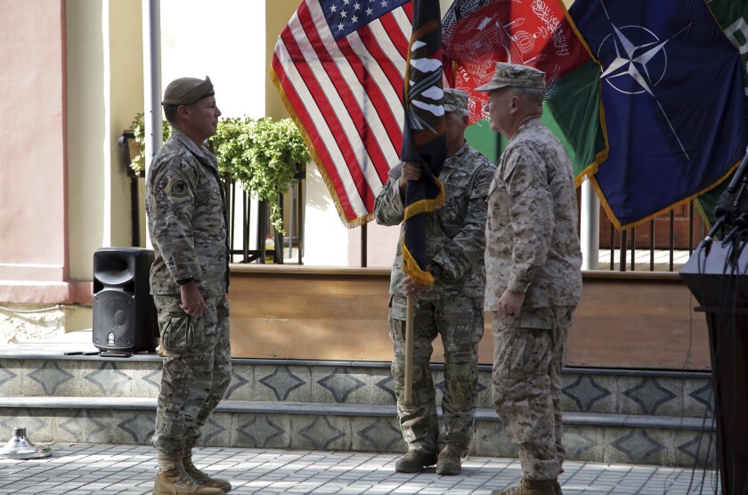 U.S. Army Gen. Scott Miller, the top U.S. commander in Afghanistan, left, hands over his command to Marine Gen. Frank McKenzie, the head of U.S. Central Command, right, at a ceremony at Resolute Support headquarters, in Kabul, Afghanistan, Monday, July 12, 2021. The United States is a step closer to ending a 20-year military presence that became known as its "forever war," as Taliban insurgents continue to gain territory across the country. (AP Photo/Ahmad Seir)