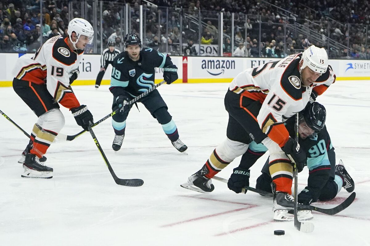 Anaheim Ducks center Ryan Getzlaf (15) and Seattle Kraken left wing Marcus Johansson (90) compete for the puck
