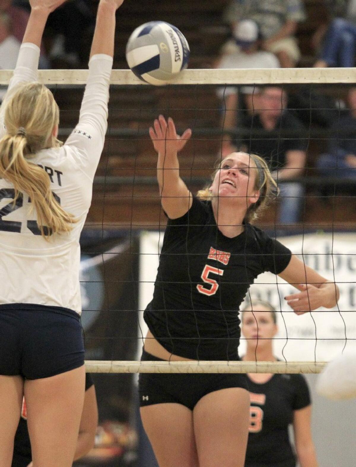 Ally Forsberg (5), seen hitting the ball past Newport Harbor's Carolyn Bockrath, played four years of varsity volleyball.