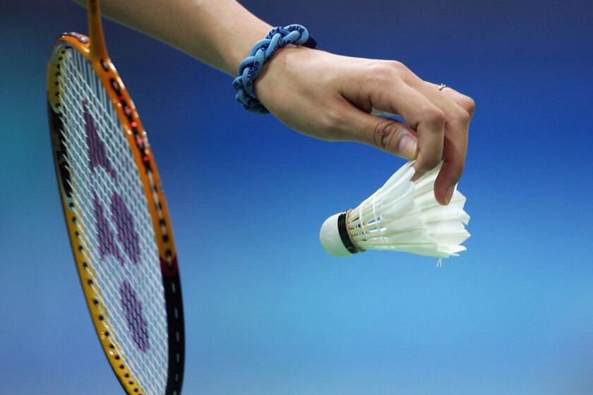 ATHENS - AUGUST 15: A competitor prepares to serve in the women's singles badminton match on August 15, 2004 during the Athens 2004 Summer Olympic Games in Olympic Hall at the Goudi Olympic Complex in Athens, Greece. (Photo by Andy Lyons/Getty Images) ORG XMIT: 51086583