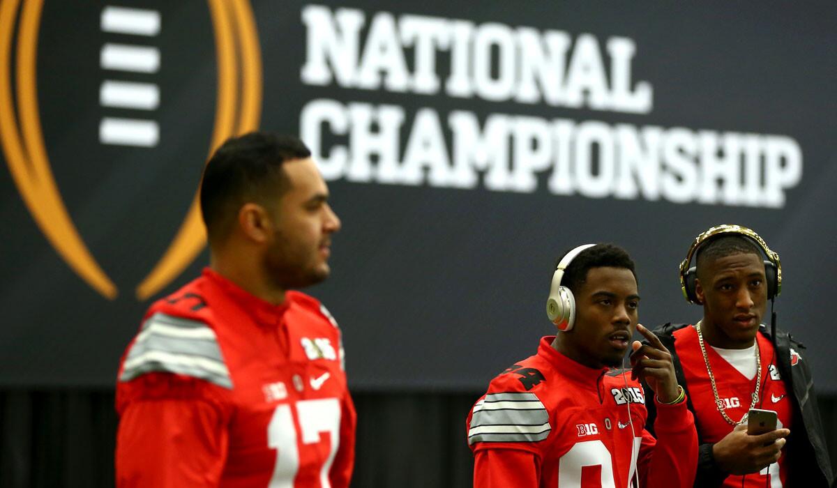 Ohio State players (from left) Jalin Marshall, Corey Smith and Michael Thomas arrive for the College Football Playoff media day on Saturday in Dallas.
