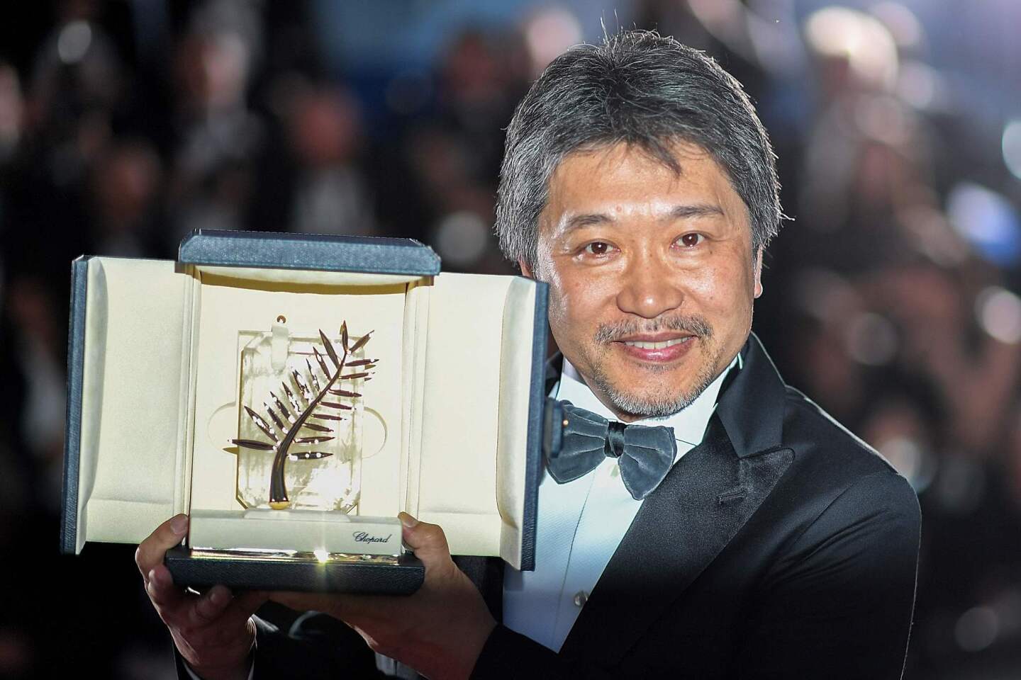 Japanese director Hirokazu Kore-Eda poses with his trophy during a photocall after he won the Palme d'Or for the film "Shoplifters (Manbiki Kazoku)" at the 71st edition of the Cannes Film Festival.
