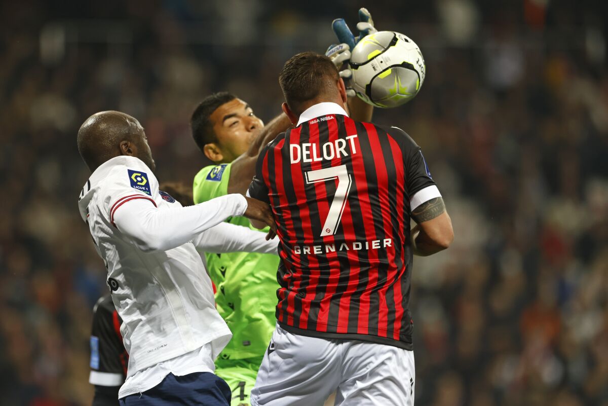 Nice's Andy Delort challenges for the ball during the French League One soccer match between Nice and Paris Saint-Germain in Nice, France, Saturday, March 5, 2022. (AP Photo/Jean-Francois Badias)