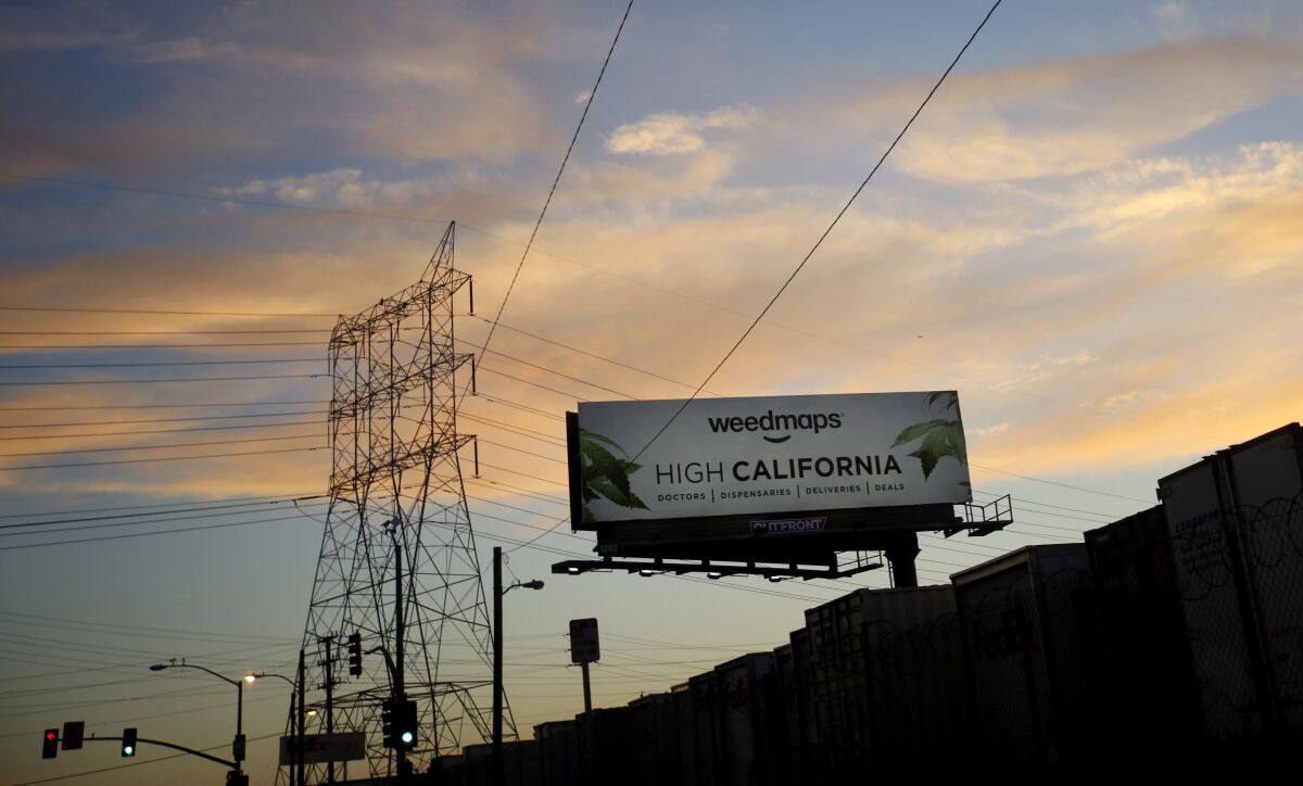 A billboard advertises Weedmaps, which helps customers locate cannabis shops.