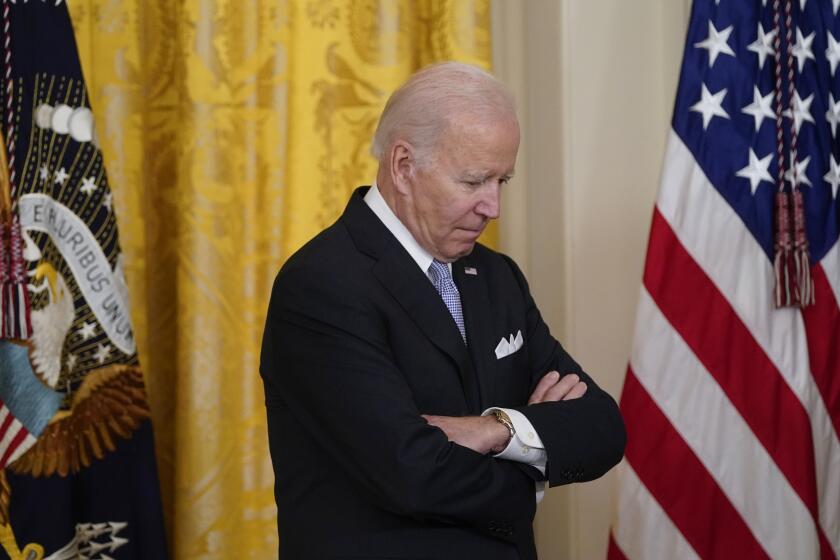 President Joe Biden listens to Vice President Kamala Harris speak before he signs an executive order in the East Room of the White House, Wednesday, May 25, 2022, in Washington. The order comes on the second anniversary of George Floyd's death, and is focused on policing. (AP Photo/Alex Brandon)