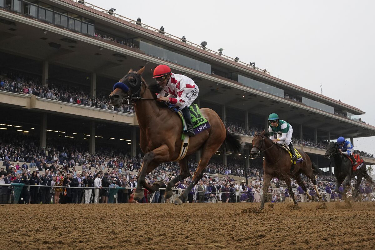 Mike Smith, left, rides Corniche to win the Breeders' Cup Juvenile race at the Del Mar racetrack in Del Mar, Calif., Friday, Nov. 5, 2021. (AP Photo/Gregory Bull)