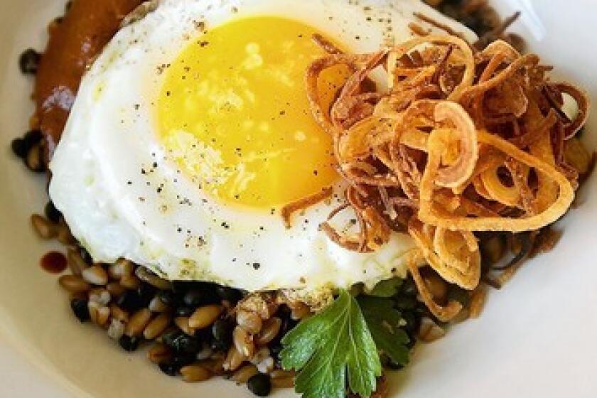 Farro and lentils with fried shallots, harissa and a fried egg are served for brunch at Cortez in Los Angeles.