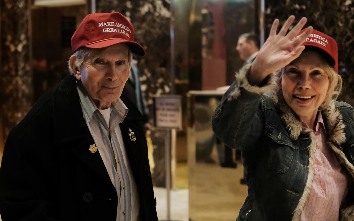 Donald Trump supporters walk through the lobby of Trump Tower as the media congregates in the lobby on Friday, Nov. 18, 2016 in New York City.