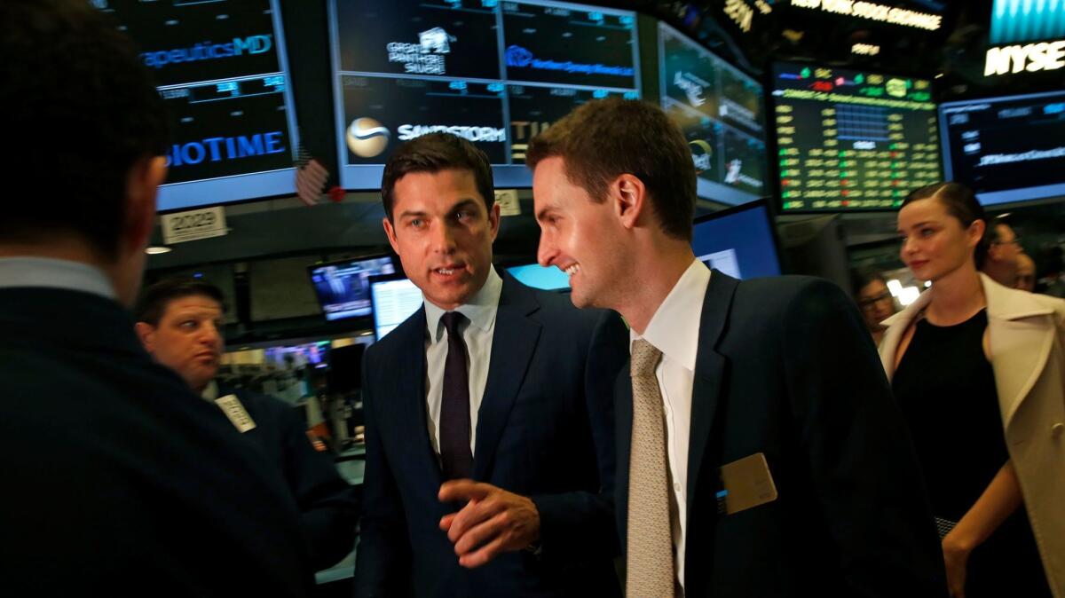 Snap Inc. Chief Executive Evan Spiegel, right, enters the trading floor before he rings the bell at the New York Stock Exchange for its Wall Street debut.