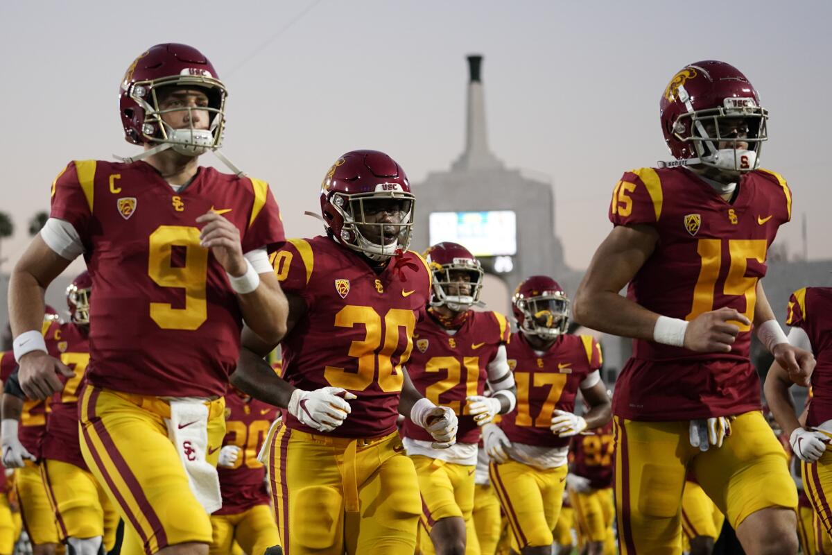 USC players run off the field after warming up against Oregon for the Pac-12 Conference championship.