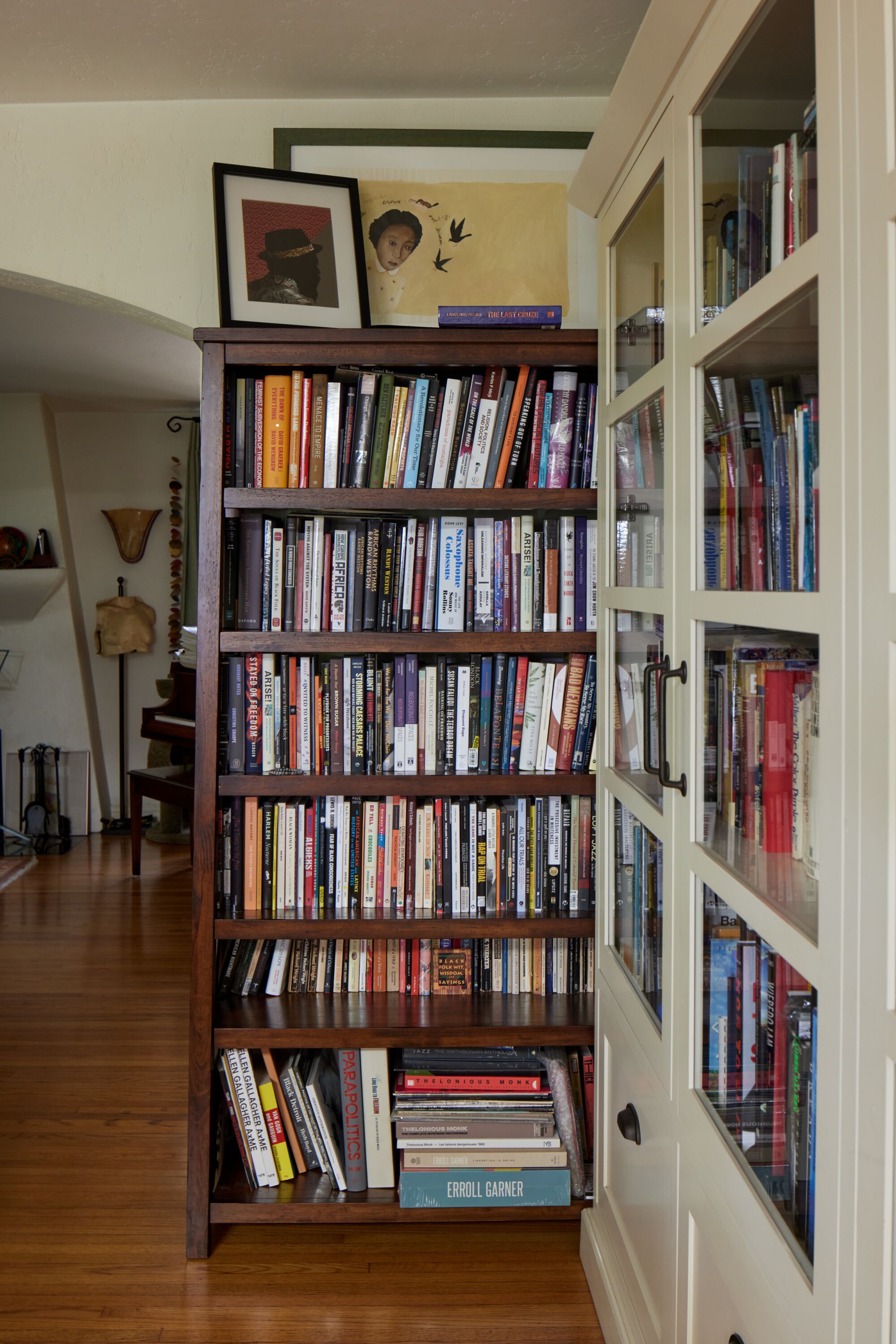 A photo of two bookshelves converging on perpendicular walls.
