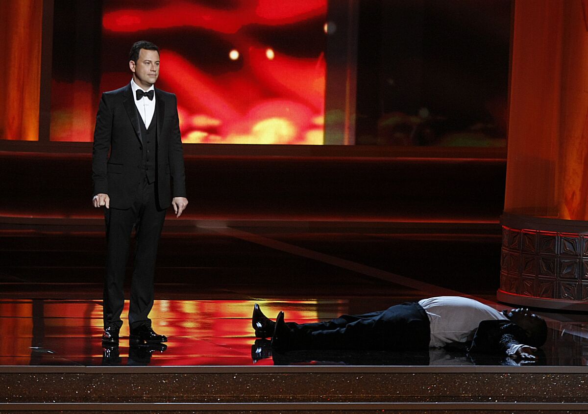 A prone Tracy Morgan, right, is part of a Jimmy Kimmel Internet prank to boost ratings during coverage of the 64th Primetime Emmy Awards show on Sept. 23, 2012.