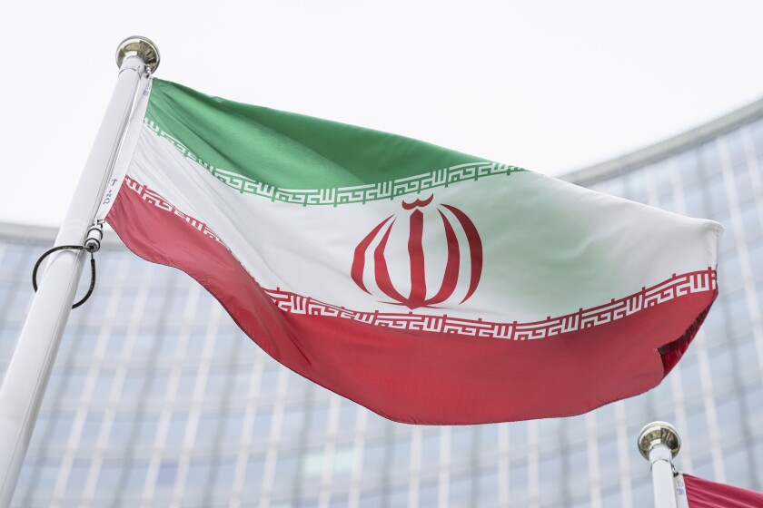 FILE - The flag of Iran waves in front of the the International Center building with the headquarters of the International Atomic Energy Agency, IAEA, in Vienna, AustriaI, May 24, 2021. On Monday, Nov. 29, 2021, negotiators are gathering in Vienna to resume efforts to revive Iran's 2015 nuclear deal with world powers, with hopes of quick progress muted after the arrival of a hard-line new government in Tehran led to a more than five-month hiatus. (AP Photo/Florian Schroetter, FILE)
