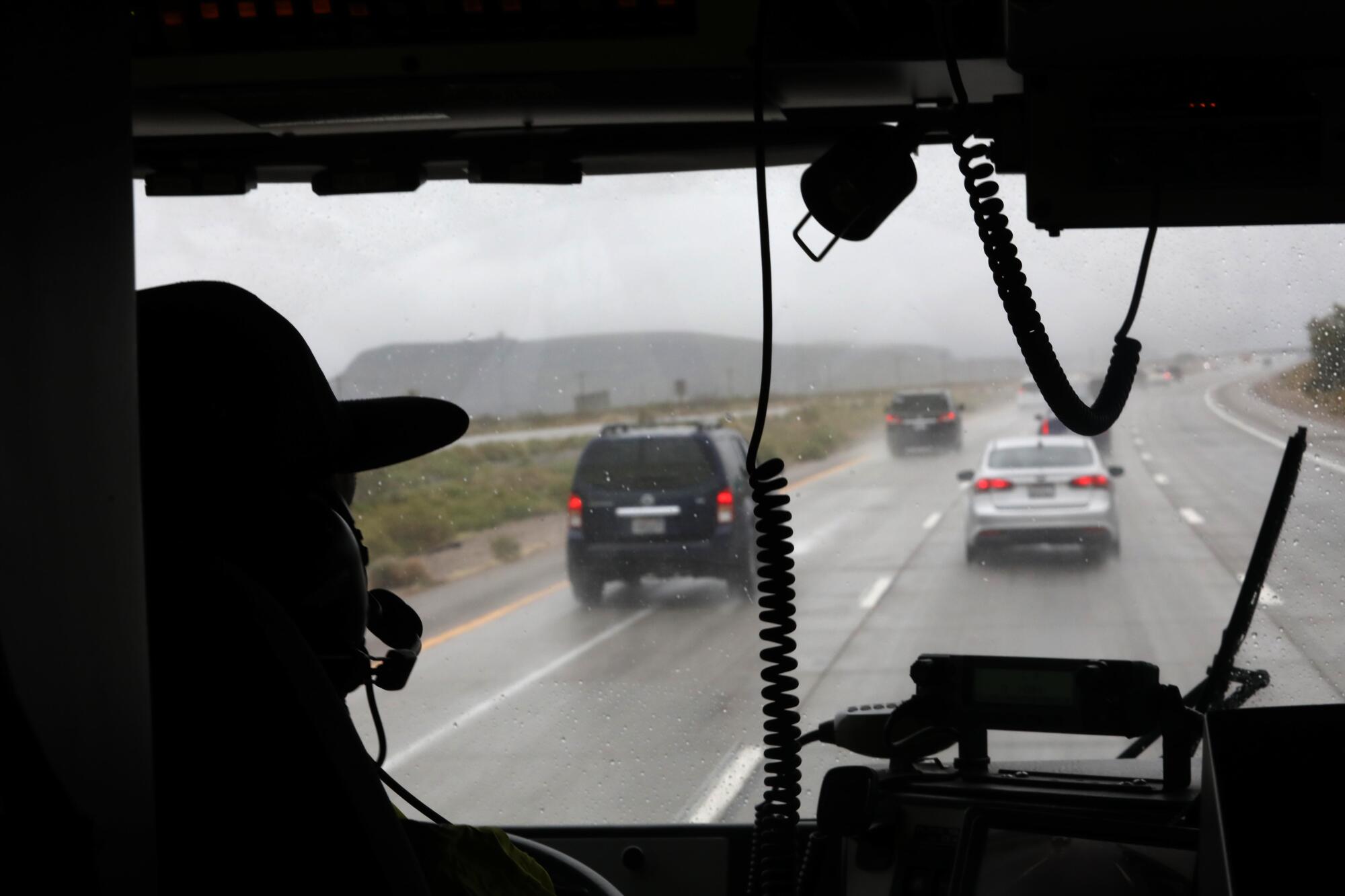 Jeff Garcia drives through the rain en route tp an overturned car with possible injuries along I-15 north of Baker.
