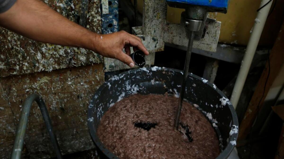 Coloring is added to the pulp as paper is made in the Mixografia workshop in Los Angeles.