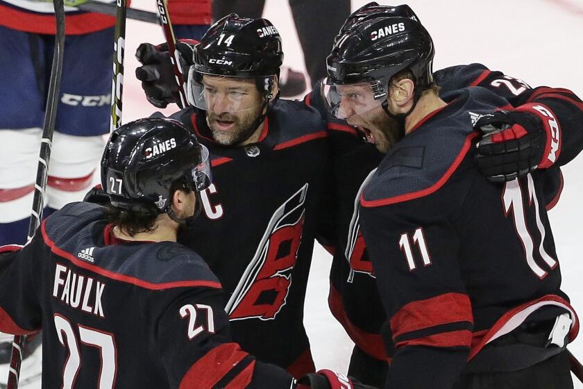 Carolina Hurricanes' Jordan Staal (11), Justin Faulk (27) and Justin Williams (14) celebrate Staal's goal against the Washington Capitals during the third period of Game 6 of an NHL hockey first-round playoff series in Raleigh, N.C., Monday, April 22, 2019. (AP Photo/Gerry Broome)