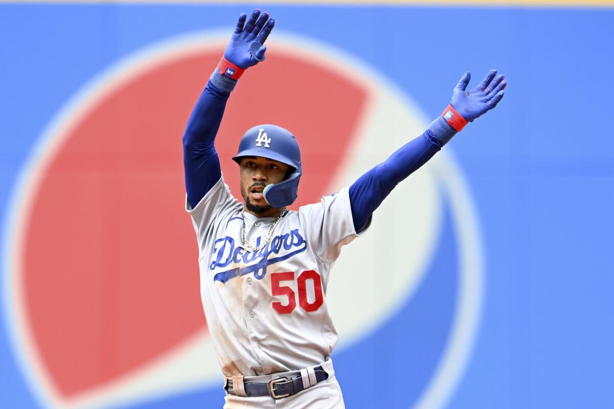 Mookie Betts celebrates after hitting a two-run double for the Dodgers against the Cleveland Guardians.