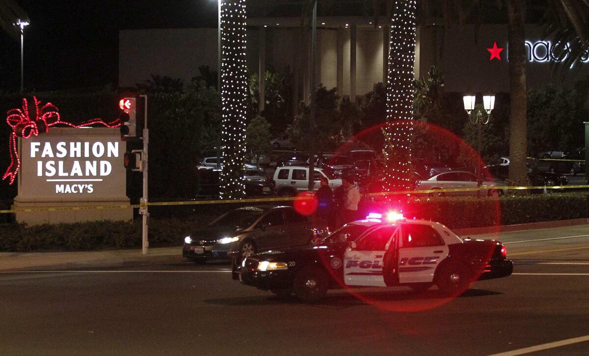A police car blocks the entrance to Fashion Island following last year's shooting.