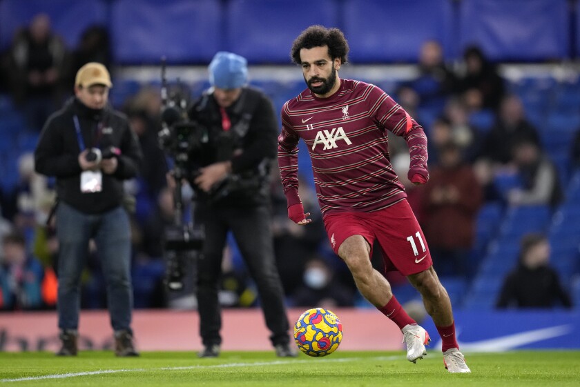 Liverpool's Mohamed Salah warms-up before the English Premier League soccer match between Chelsea and Liverpool at Stamford Bridge in London, Sunday, Jan. 2, 2022. (AP Photo/Matt Dunham)