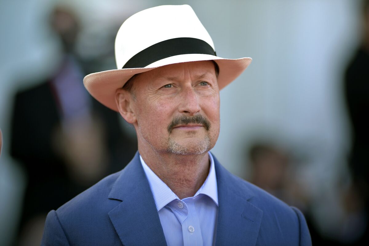 Director Todd Field wears a blue jacket and white hat.